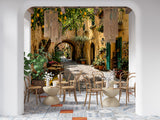 Sun-drenched Mediterranean alleyway wall mural featuring lemon trees, potted flowers, and cobblestone street in a Tuscan village style.